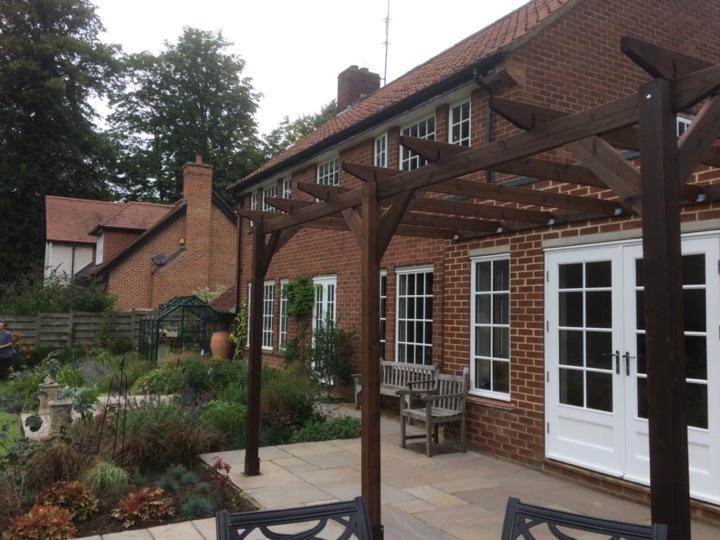 Example of a pergola built on a patio up against a house